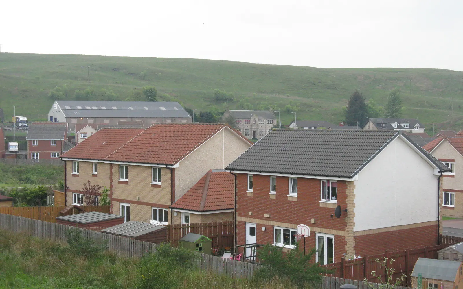Houses at Craigsmill Wynd, Caldercruix, with hills behind