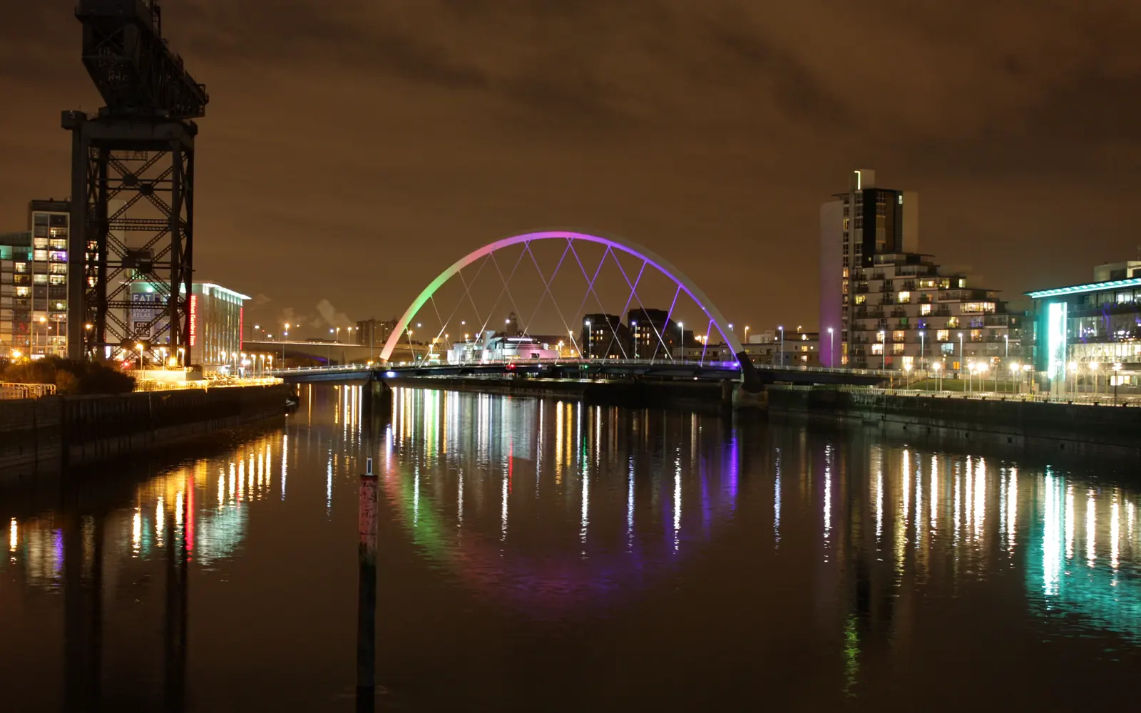 Glasgow skyline at night with the Clyde Arc lit up over the river